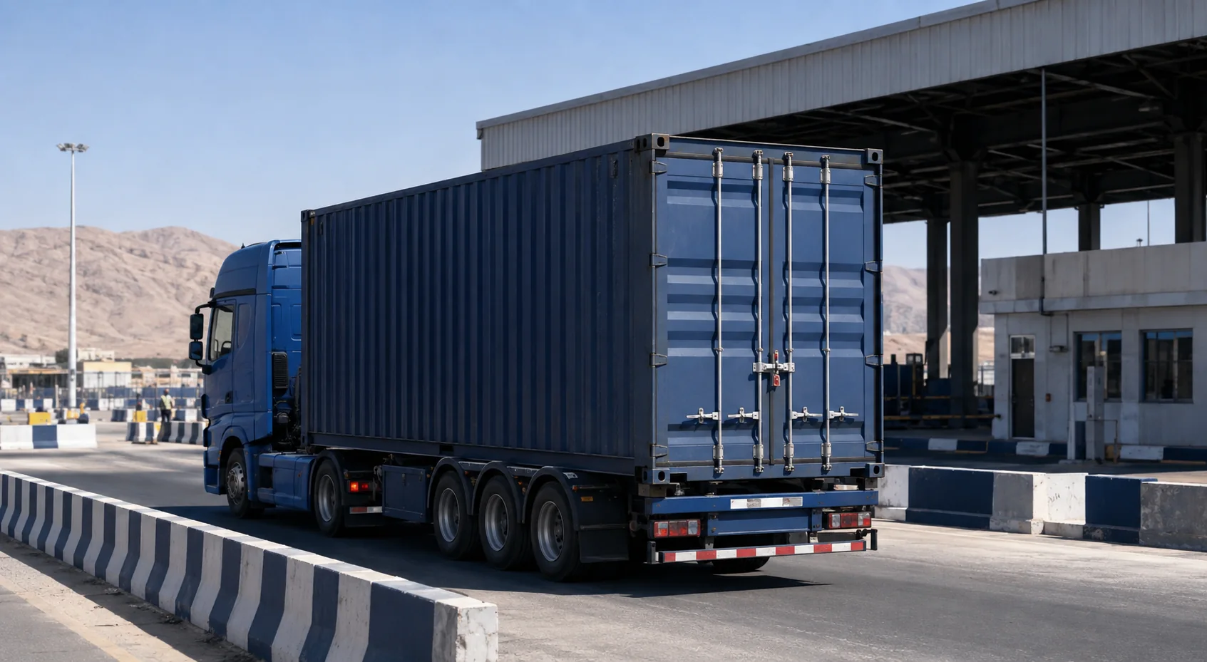 Blue cargo truck and customs-sealed container at a TIR border checkpoint